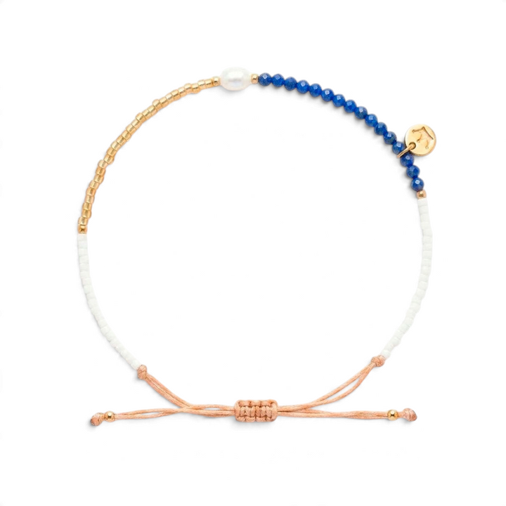 Niche Jewellery Jersey Pearl Noma bracelet featuring blue lapis lazuli beads, a white pearl, and gold-tone accents.