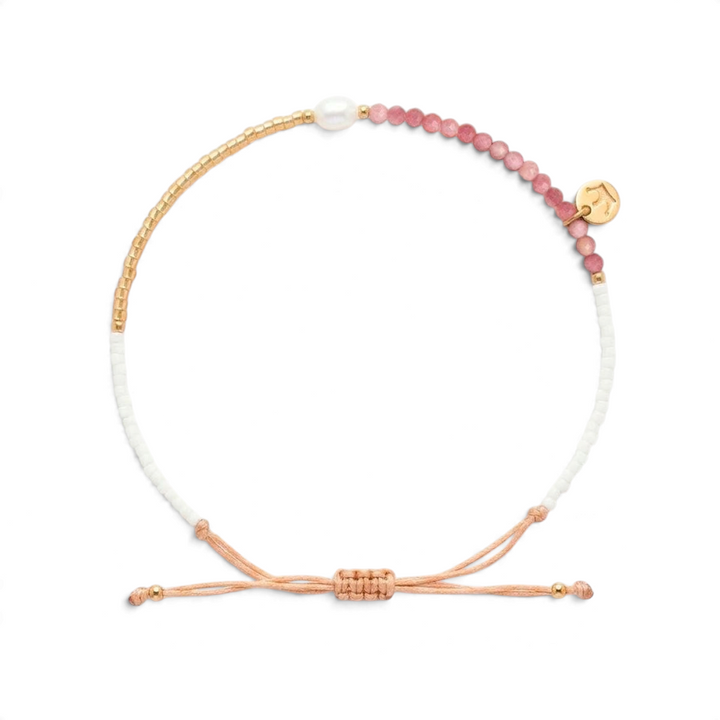 Niche Jewellery Jersey Pearl Noma bracelet featuring pink rhodochrosite beads, a white pearl, and gold-tone accents.