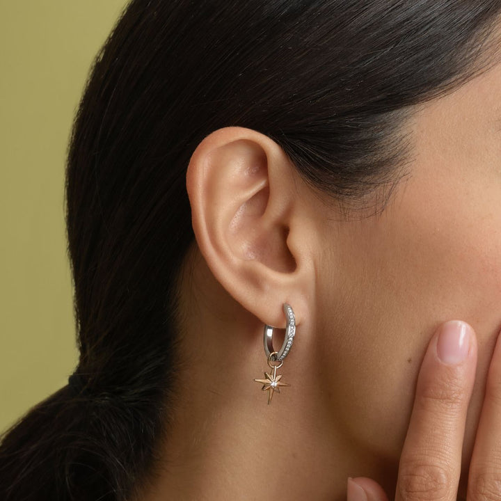 Olivia Burton Signature Celestial Star and Moon Silver Tone Huggie Earrings. Item code 24100472.