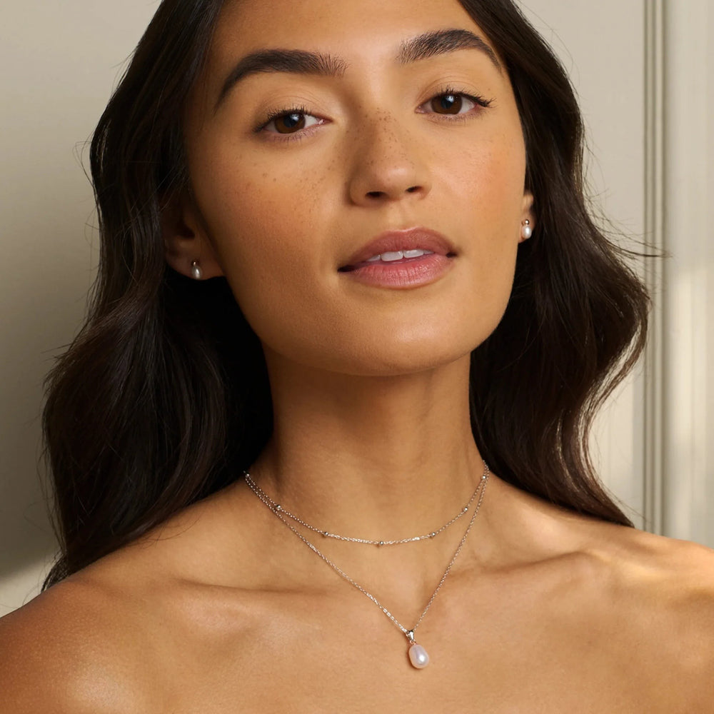 Niche Jewellery: Clogau sterling silver layered necklace with a single pearl pendant and small silver beads on the chains.