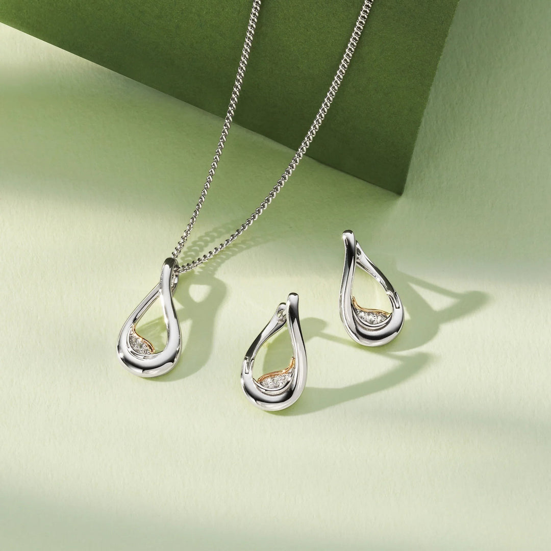 Niche Jewellery: Clogau sterling silver twist pendant with rose gold accent and white topaz stones. Adjustable chain.