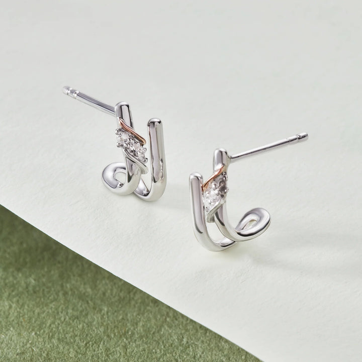 Niche Jewellery: Clogau sterling silver curve stud earrings with rose gold accent and white topaz stones.
