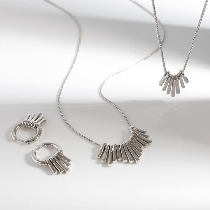 Niche Jewellery Kit Heath rhodium-plated sterling silver dangle hoop drop earrings with five graduating pendants.