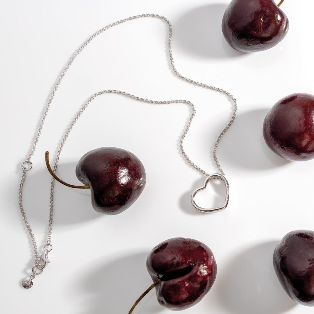 Niche Jewellery: Kit Heath sterling silver necklace with a delicate heart outline pendant that sits at a subtle angle.