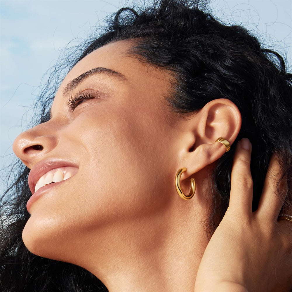 Niche Jewellery Ania Haie Classic Tube Medium Huggie Hoop Gold Earrings worn on model
