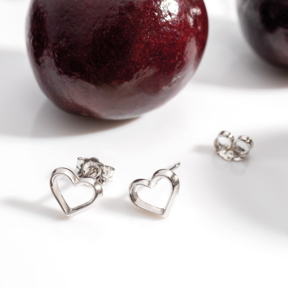 Niche Jewellery: Kit Heath sterling silver heart outline stud earrings. Delicate and refined, perfect for everyday wear.
