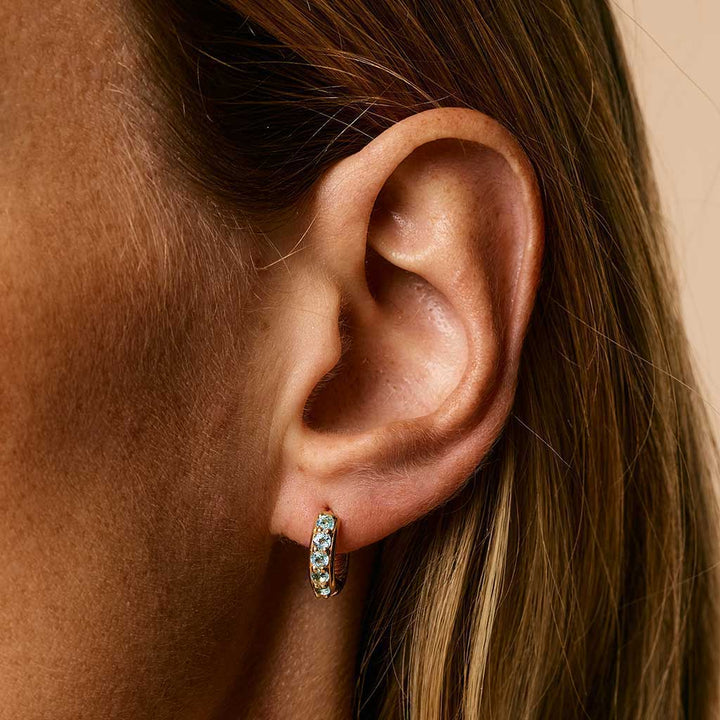 Charlotte's Web Kali Huggie Hoops - Gold Blue Topaz