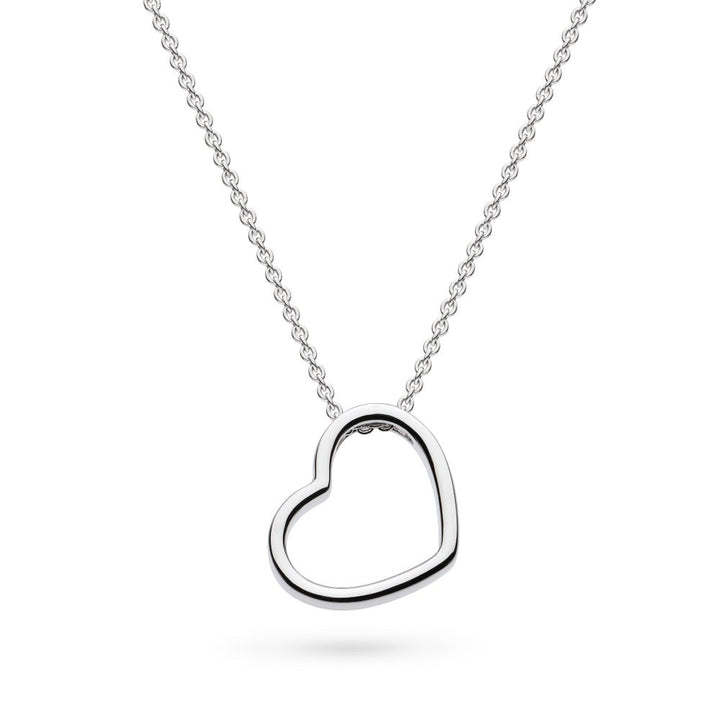 Niche Jewellery: Kit Heath sterling silver necklace with a delicate heart outline pendant that sits at a subtle angle.