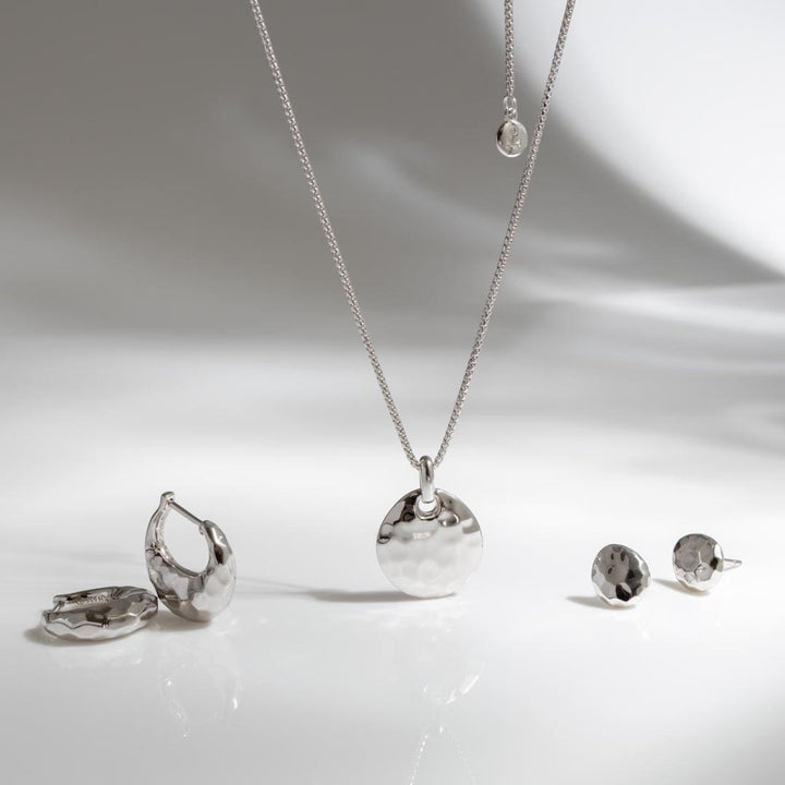 Kit Heath Mirage Reflect sterling silver hinged hoop earrings with dappled texture.