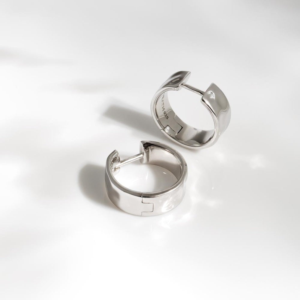 Kit Heath Mirage Reflect wide hinged hoop earrings in Sterling Silver with a dappled texture.