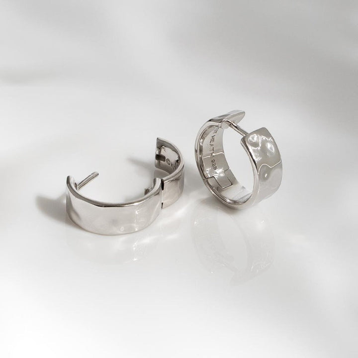 Kit Heath Mirage Reflect Wide Hinged Hoop Earrings in Sterling Silver with a dappled texture. Hinged design.