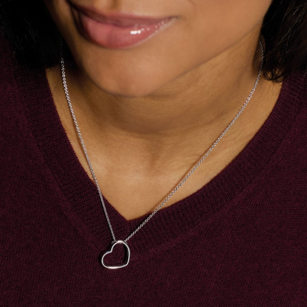 Niche Jewellery: Kit Heath sterling silver necklace with a delicate heart outline pendant that sits at a subtle angle.