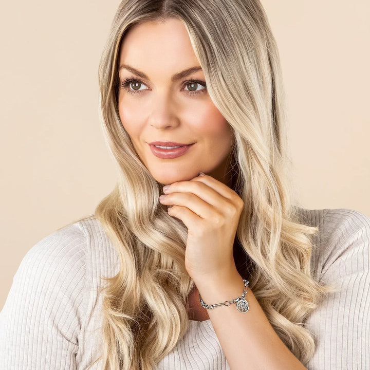 Niche Jewellery: Clogau sterling silver Figaro bracelet with rose gold Tree of Life charm, symbolising strength and renewal.