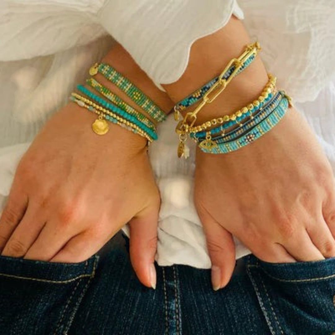 Niche Jewellery Boho Betty Brela Blue Evil Eye Charm Bracelet with turquoise stones, gold accents, and adjustable slider.