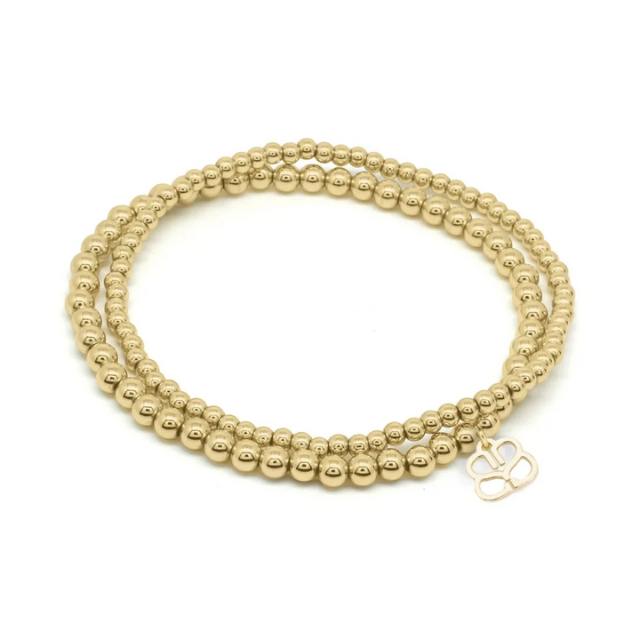 Niche Jewellery Boho Betty Kamini gold stretch bead bracelet set with 3mm and 4mm beads and a charm.