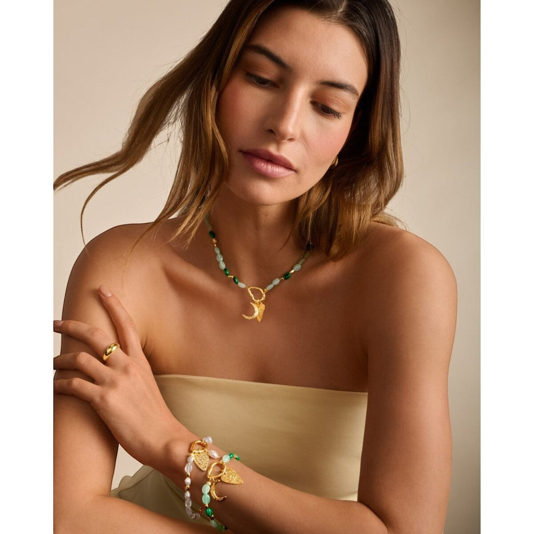 Niche Jewellery Katie Loxton Palma Solesi gold bracelet with green beads, crescent moon and evil eye charms. Waterproof.