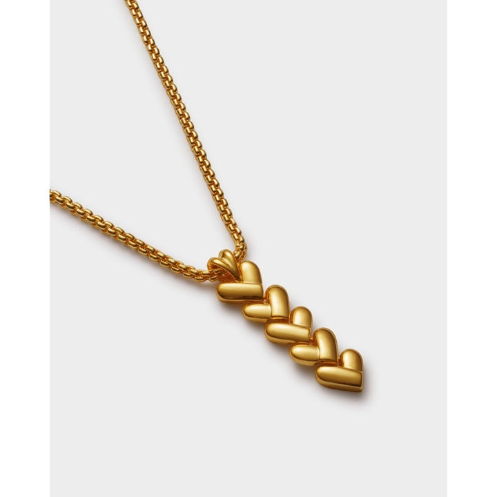 Niche Jewellery Katie Loxton gold necklace with a vertical row of five heart-shaped links on a delicate chain. Waterproof and sweat-proof.