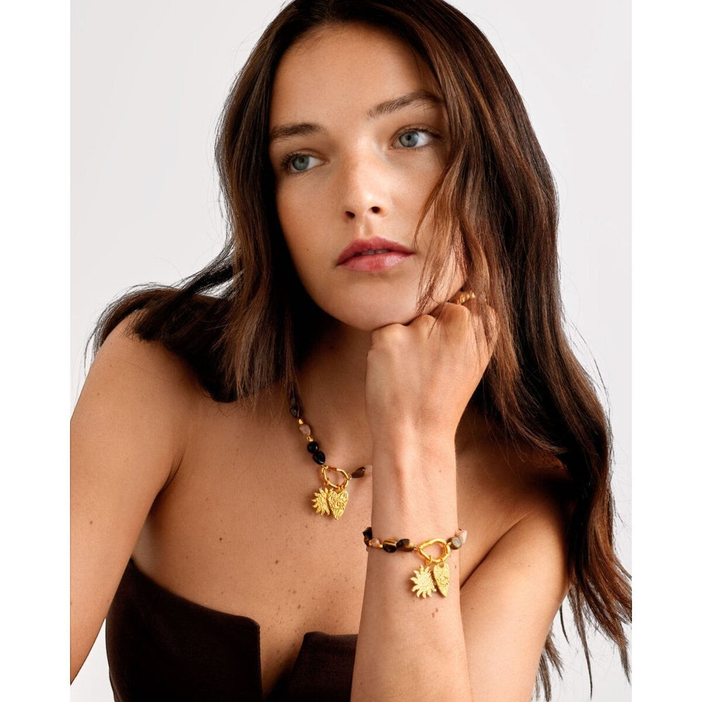 Niche Jewellery: Katie Loxton Sunset Solesi necklace with gold PVD coating, tiger's eye and rose quartz beads, and sun and eye charms.