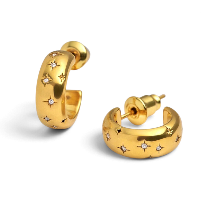 Niche Jewellery Katie Loxton gold hoop earrings featuring scattered star engravings and small sparkling crystals.