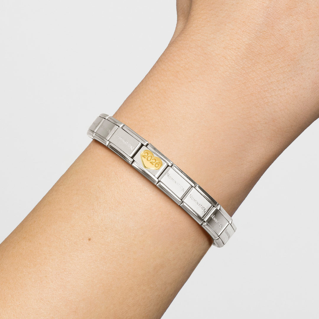 Niche Jewellery Nomination 2026 heart charm in 18k gold and stainless steel on a classic link bracelet