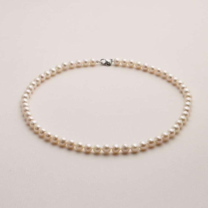 Niche Jewellery Jersey Pearl 7mm signature freshwater pearl necklace with a silver clasp on a neutral background