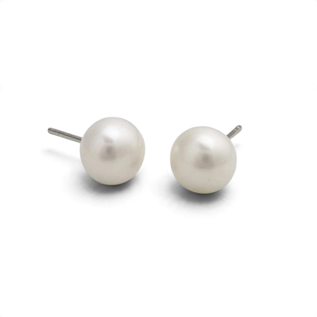 Niche Jewellery 9mm button-shaped freshwater pearl stud earrings set in sterling silver on a white background.