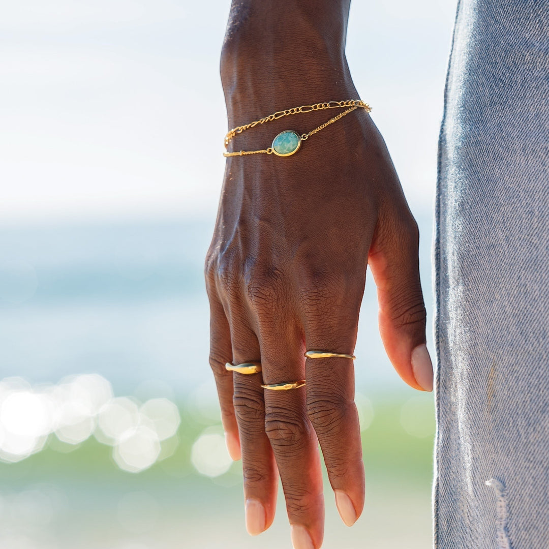 Niche Jewellery Sarah Alexander gold-plated bobble chain bracelet with a round amazonite gemstone on a model's wrist.