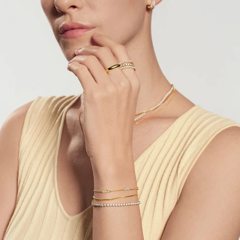 Niche Jewellery Ania Haie gold-plated cluster station bracelet with cubic zirconia stones on a model's wrist