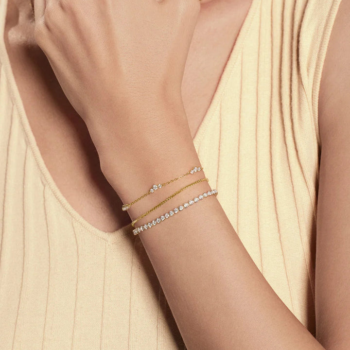 Niche Jewellery Ania Haie gold-plated cluster station bracelet with cubic zirconia stones on a woman's wrist