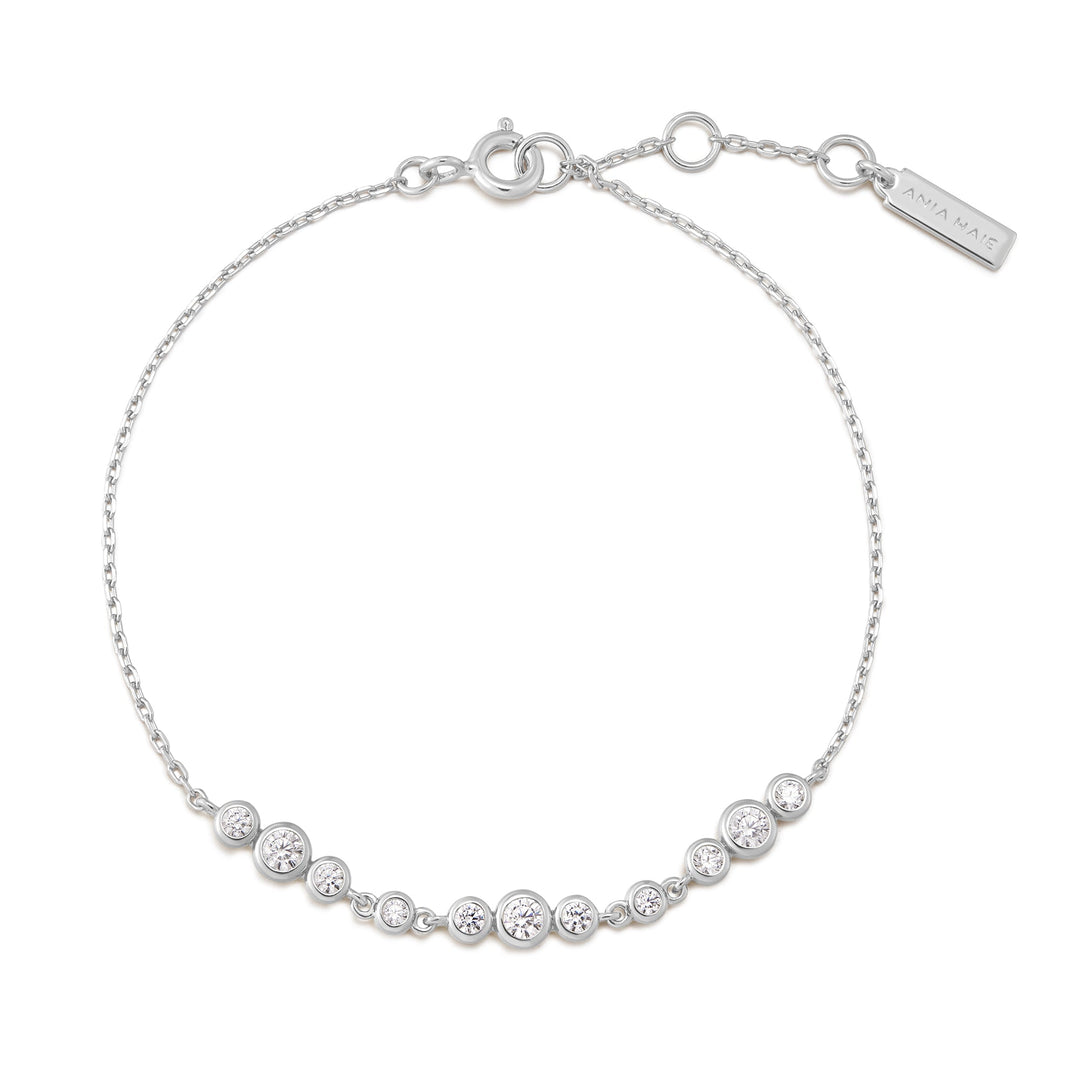 Niche Jewellery Ania Haie rhodium-plated sterling silver bracelet with graduated bezel-set cubic zirconia trios.