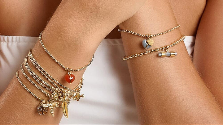 Niche Jewellery Annie Haak Santeenie Imogen heart charm bracelet in burnt orange with gold-filled beads on a wrist