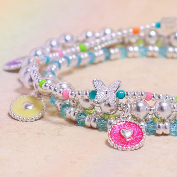 Niche Jewellery Annie Haak Papillon silver bracelet with neon beads, butterfly charm, and heart-shaped enamel charms.