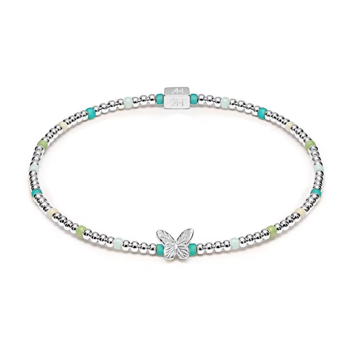 Niche Jewellery Annie Haak Papillon stretch bracelet with sterling silver beads, turquoise glass, and butterfly charm.