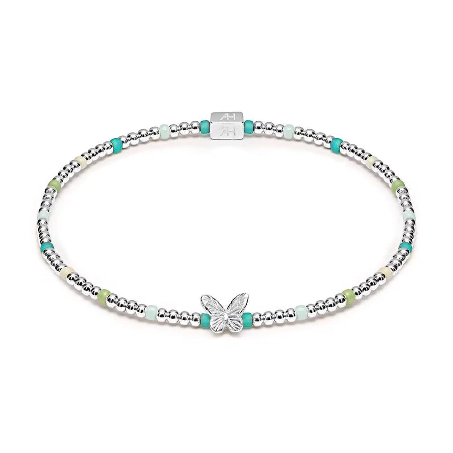 Niche Jewellery Annie Haak Papillon stretch bracelet with sterling silver beads, turquoise glass, and butterfly charm.