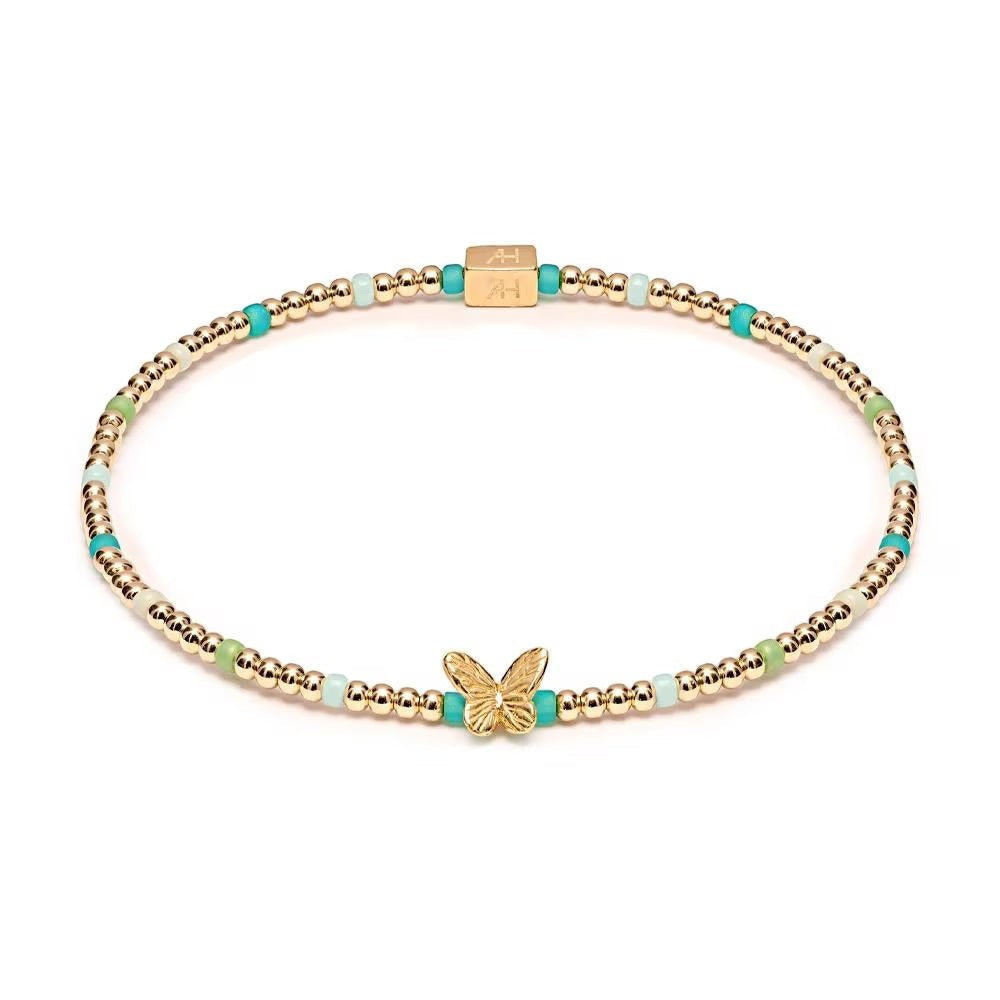 Niche Jewellery Annie Haak Papillon gold-plated stretch bracelet with turquoise, green beads, and butterfly charm.