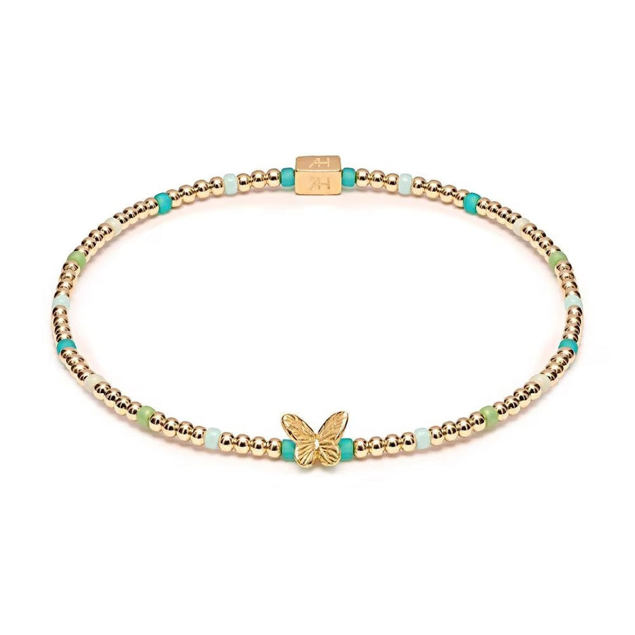 Niche Jewellery Annie Haak Papillon gold-plated stretch bracelet with turquoise, green beads, and butterfly charm.