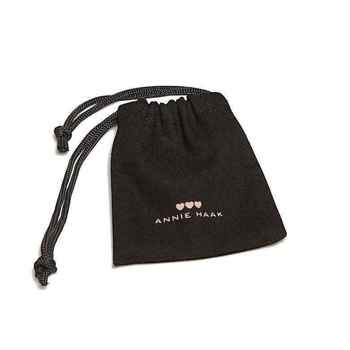 Black fabric jewellery pouch with Annie Haak logo and three heart icons, sold by Niche Jewellery