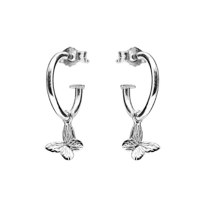 Niche Jewellery Annie Haak sterling silver hoop earrings featuring delicate butterfly charms on a white background.