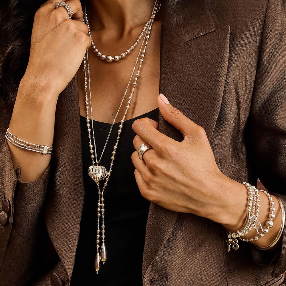 Niche Jewellery Annie Haak sterling silver spinner ring with hammered texture worn on a model in a brown blazer