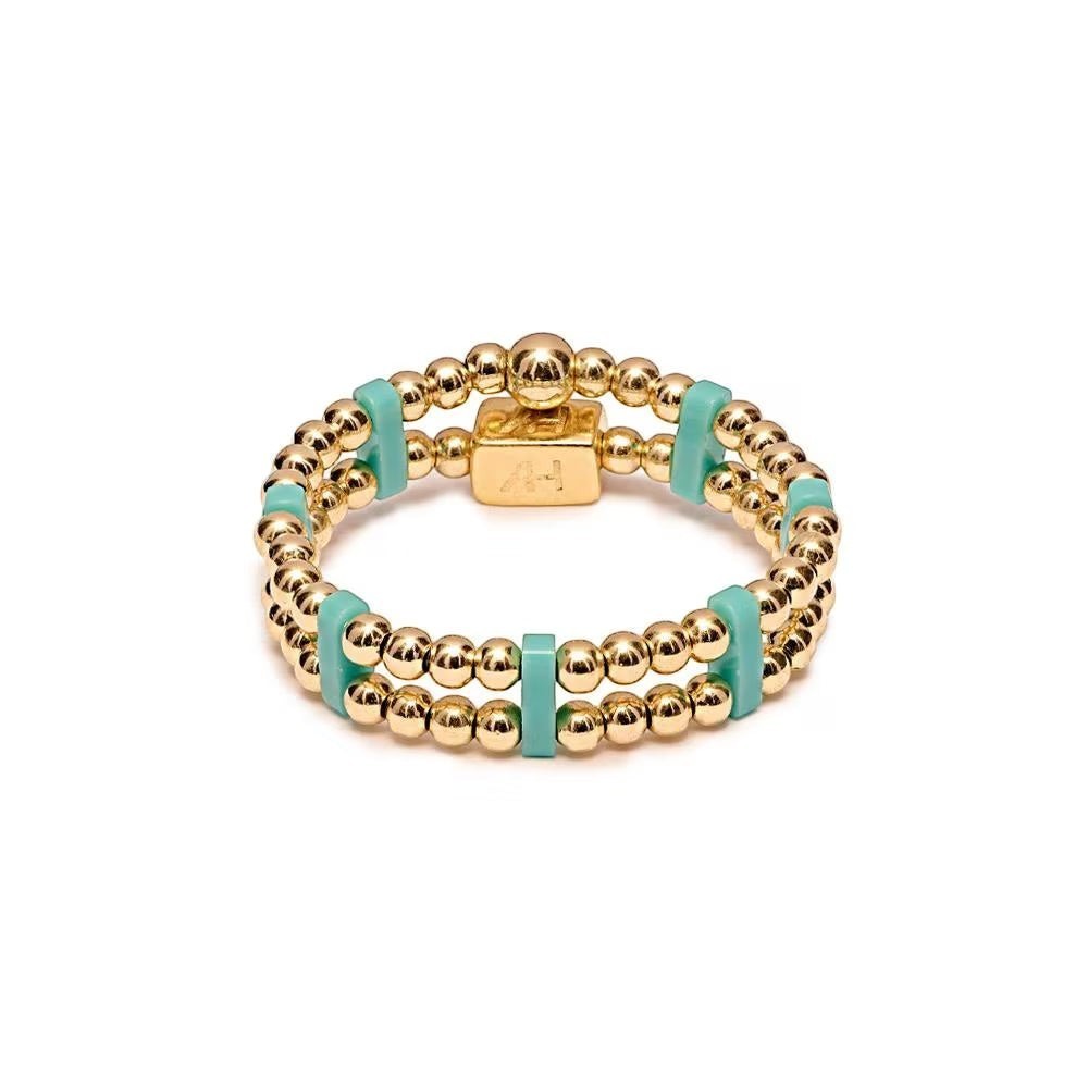 Niche Jewellery Annie Haak gold-plated double-strand ring with turquoise Miyuki beads and a signature logo charm.