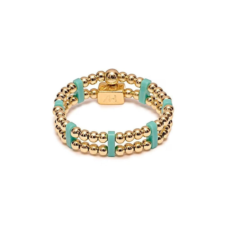 Niche Jewellery Annie Haak gold-plated double-strand ring with turquoise Miyuki beads and a signature logo charm.