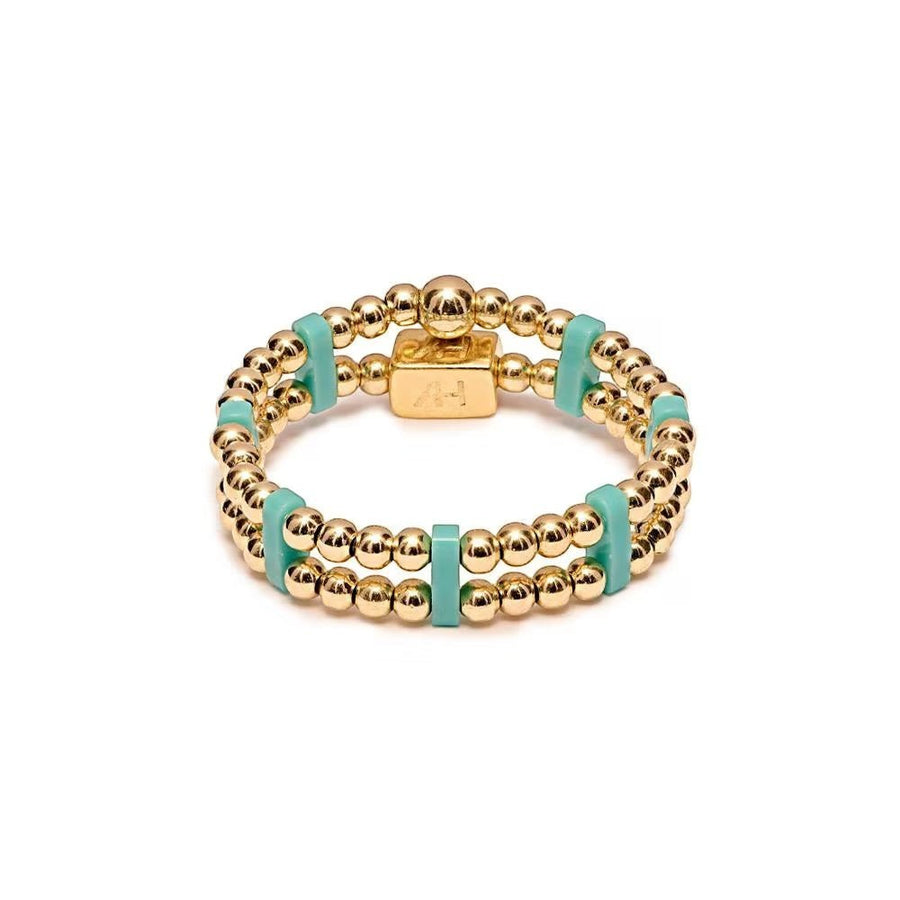 Niche Jewellery Annie Haak gold-plated double-strand ring with turquoise Miyuki beads and a signature logo charm.