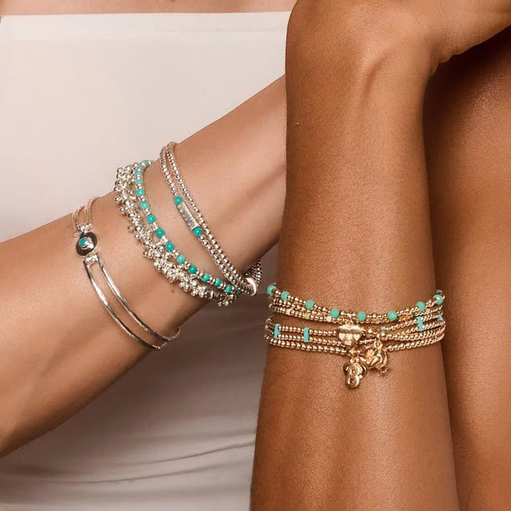 Niche Jewellery Annie Haak Joy turquoise howlite and 925 sterling silver stretch stacking bracelets on wrists.