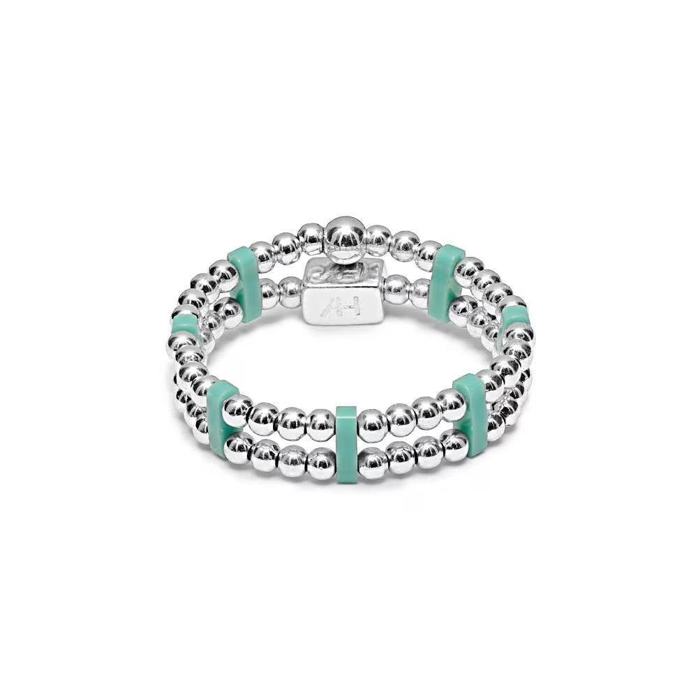 Niche Jewellery Annie Haak sterling silver stretch ring with turquoise Miyuki beads and a branded silver charm.