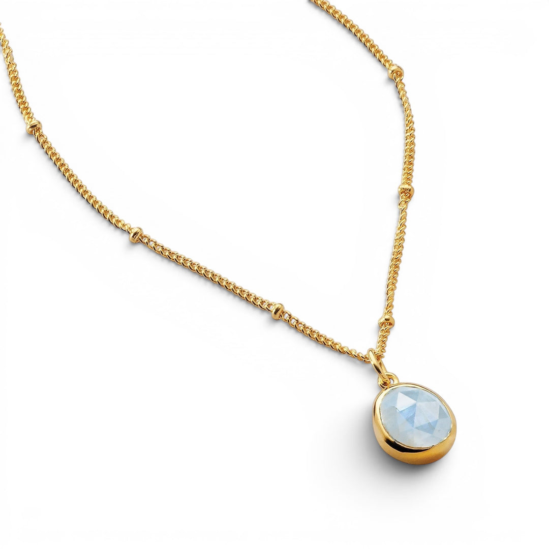 Niche Jewellery Sarah Alexander Aegean necklace featuring a pale blue aquamarine pendant on an 18ct gold bobble chain.