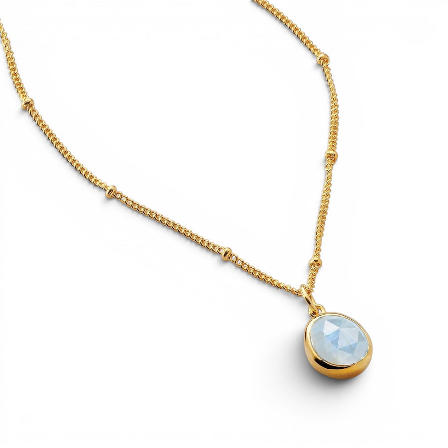 Niche Jewellery Sarah Alexander Aegean necklace featuring a pale blue aquamarine pendant on an 18ct gold bobble chain.