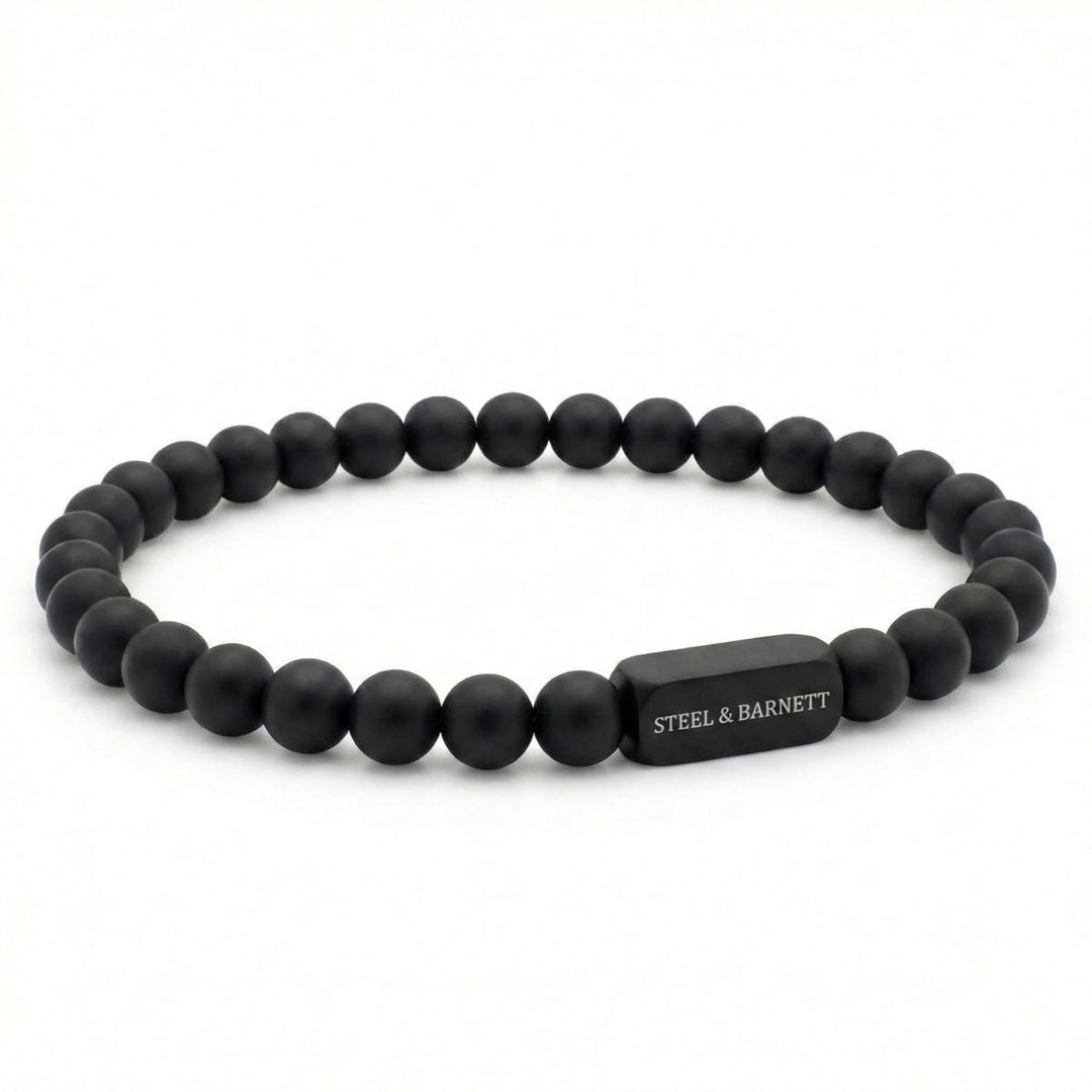 Niche Jewellery Steel & Barnett 6mm black onyx bead bracelet with a matte black stainless steel logo accent.