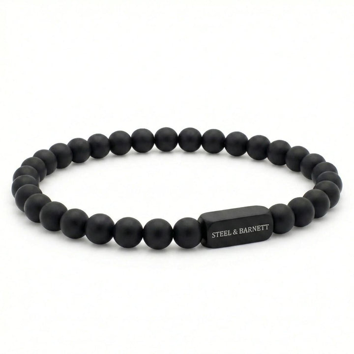 Niche Jewellery Steel & Barnett 6mm black onyx bead bracelet with a matte black stainless steel logo accent.