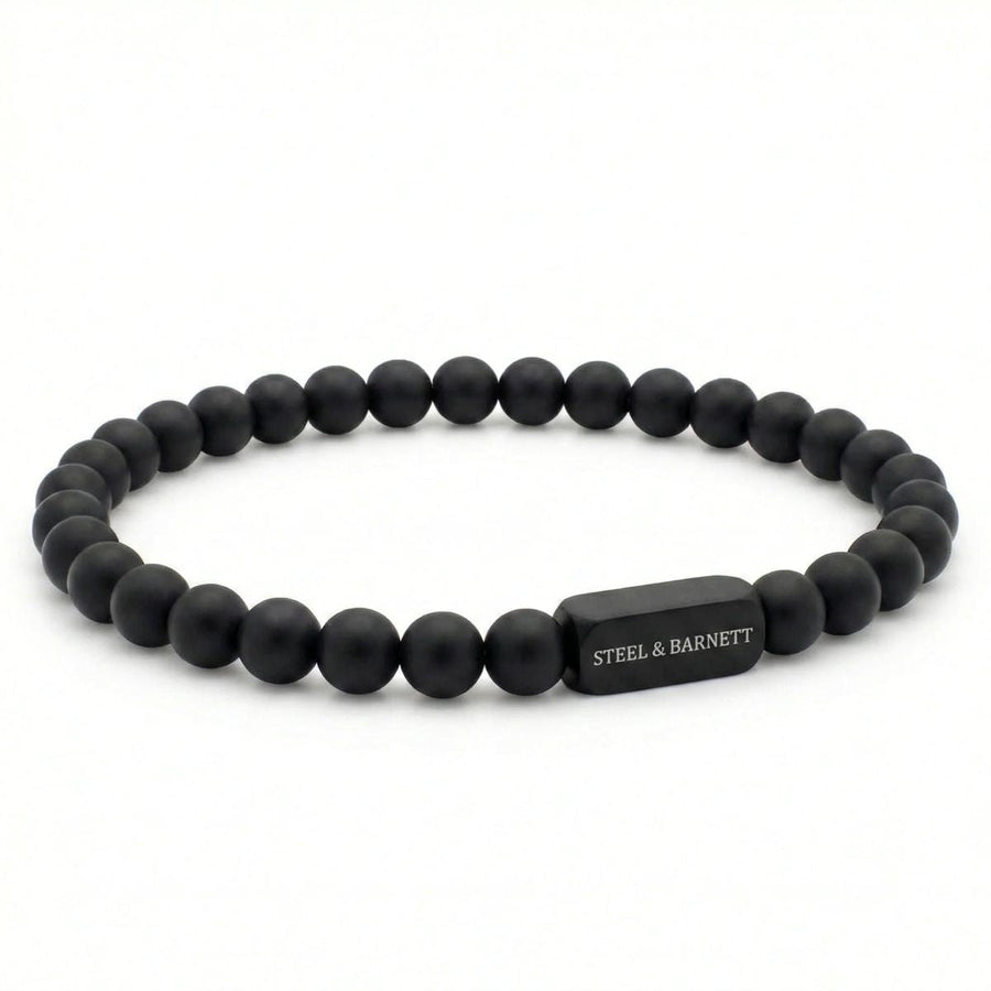 Niche Jewellery Steel & Barnett 6mm black onyx bead bracelet with a matte black stainless steel logo accent.