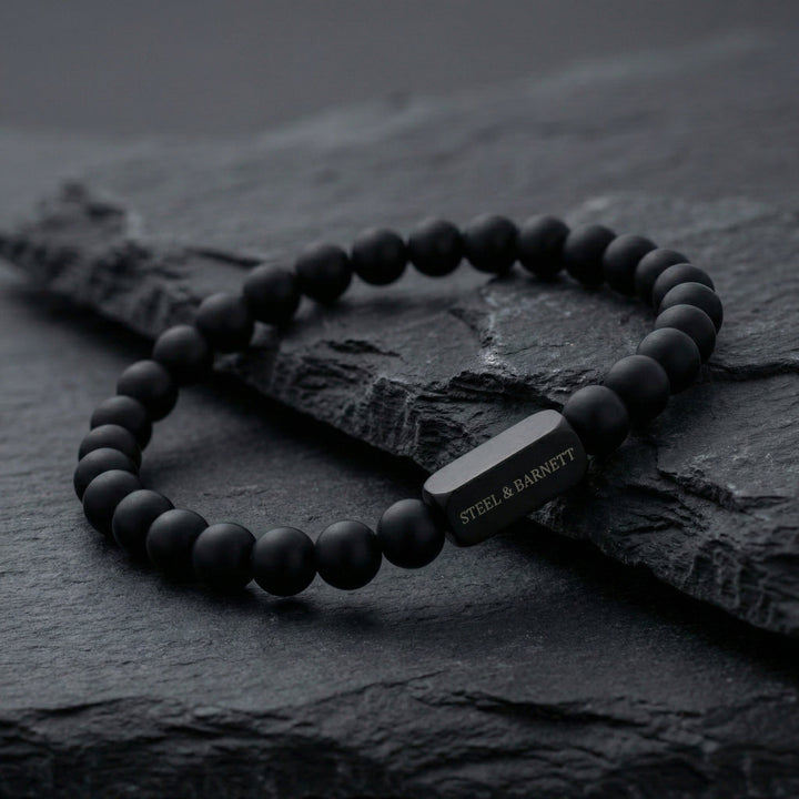 Niche Jewellery Steel & Barnett 6mm black onyx bead bracelet with a matte black stainless steel accent on slate.